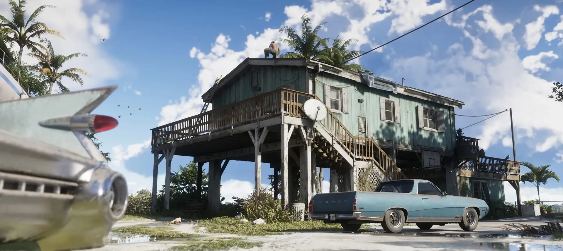 A stilt house with a man on the roof and a blue pickup by the porch