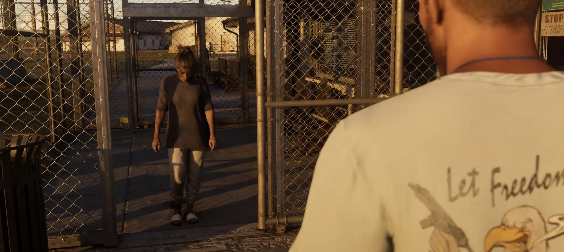 Lucia walks out through the prison gate, Jason in the foreground